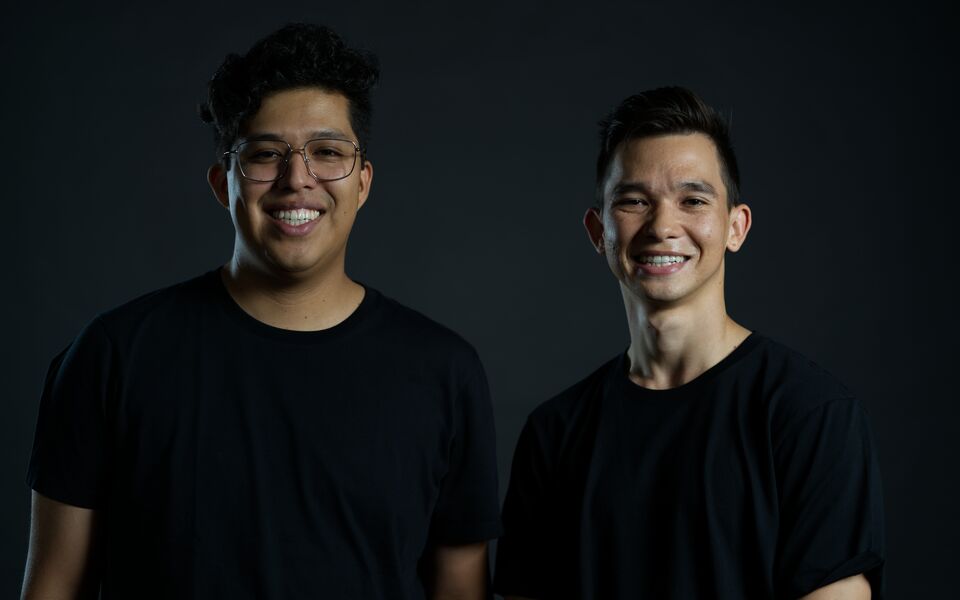 Abel Jimenez and Sam Balana, in black T-shirts against a dark backdrop.
